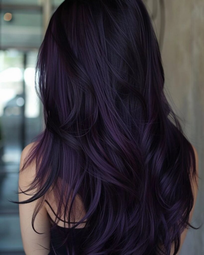 Long wavy dark purple hair cascading over a person's shoulders