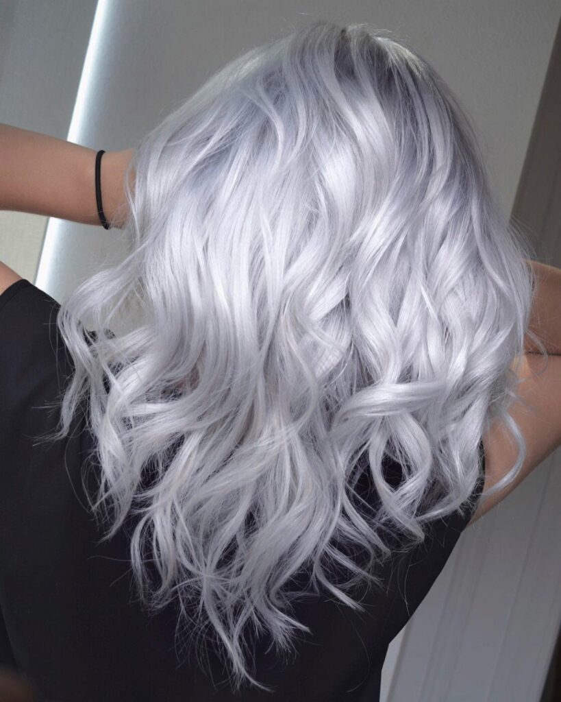 Long wavy silver hair cascading down the back of a person