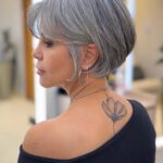 Woman showing a silver-grey bob with a long side-swept fringe