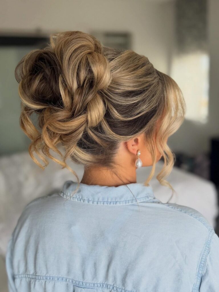 Blonde updo with curled sections and loose tendrils, viewed from behind