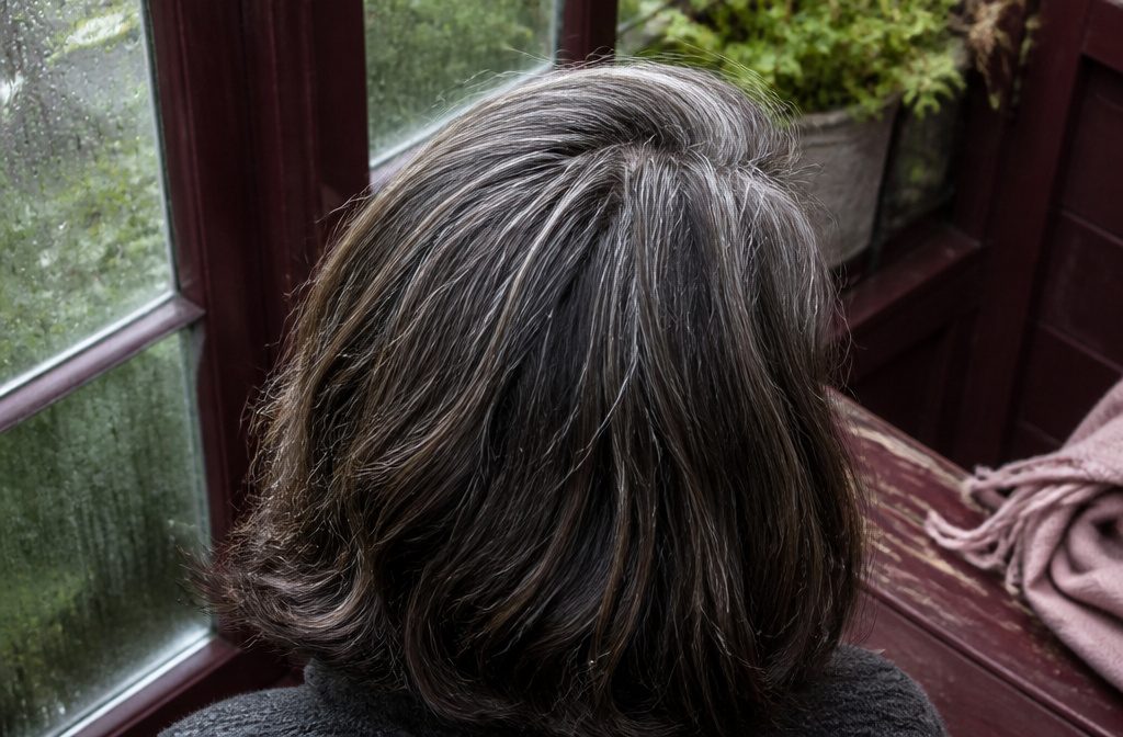 Close view of white and gray hair strands showing mixed pigmentation